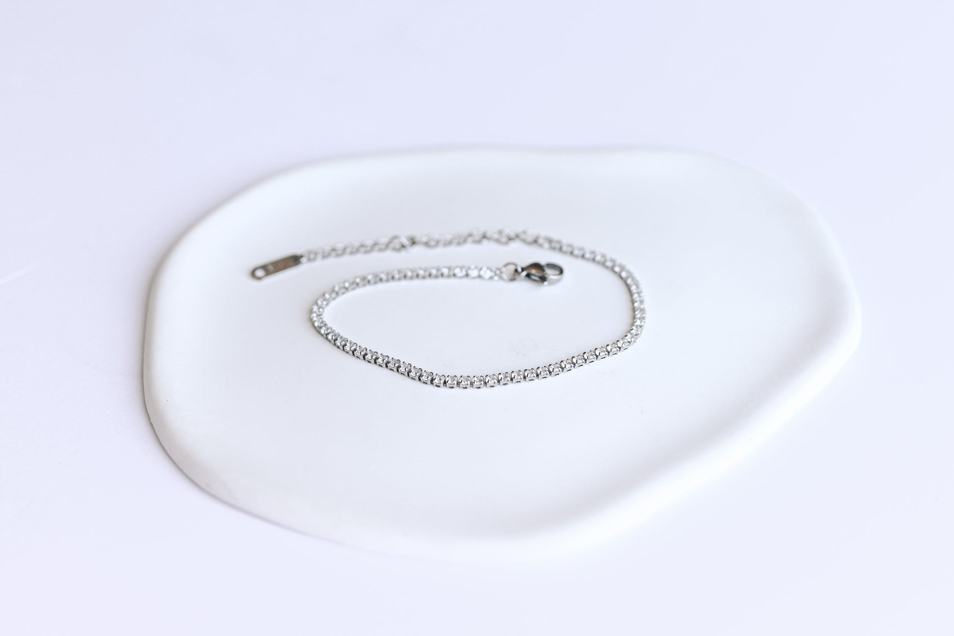 Silver stainless steel tennis bracelet with 2mm cubic zirconia.