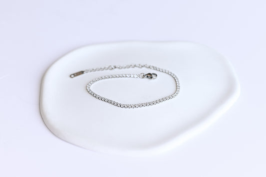 Silver stainless steel tennis bracelet with 2mm cubic zirconia.