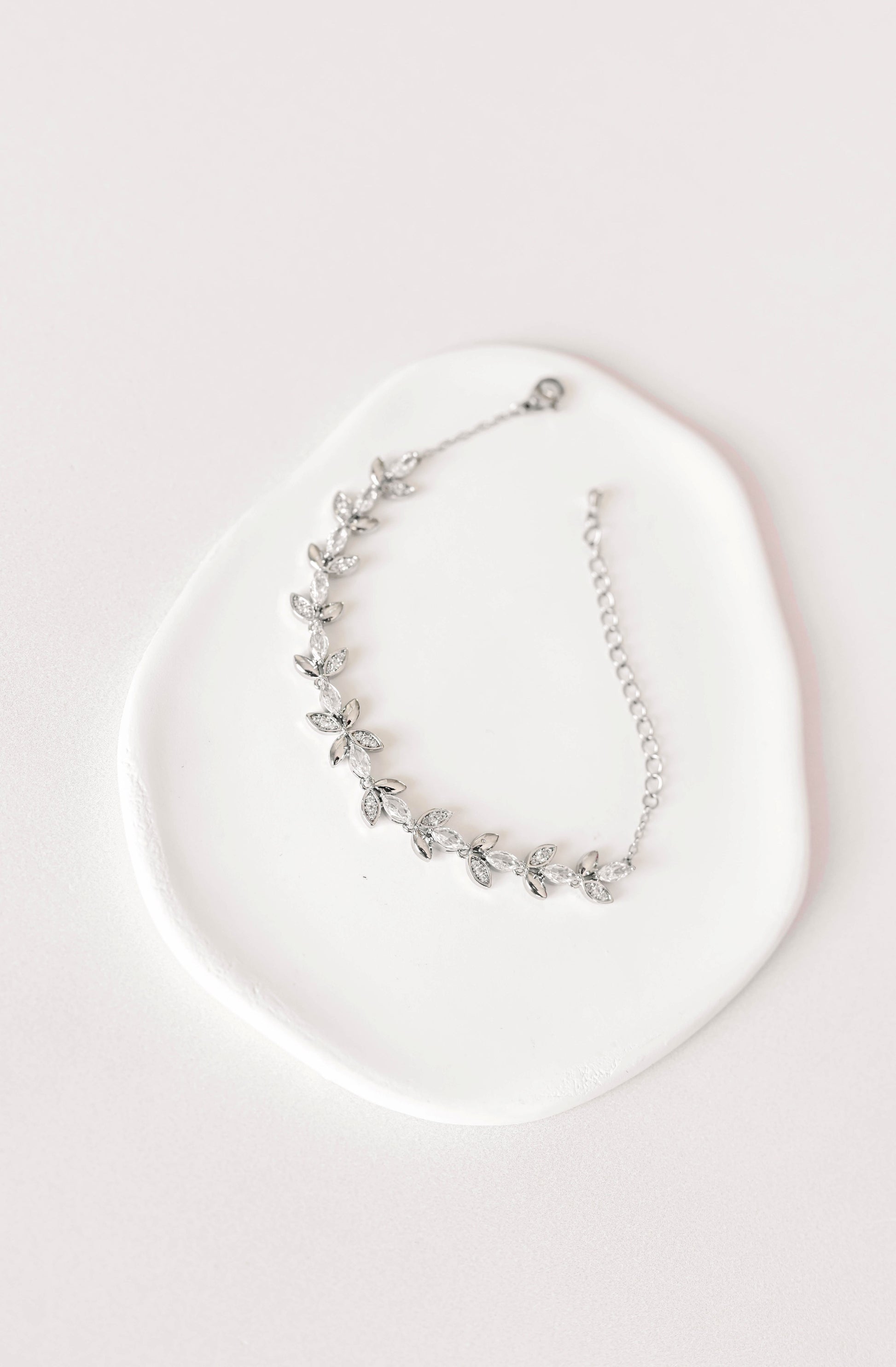 Silver bridal bracelet with cubic zirconia leaf design.