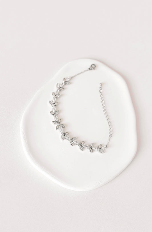 Silver bridal bracelet with cubic zirconia leaf design.