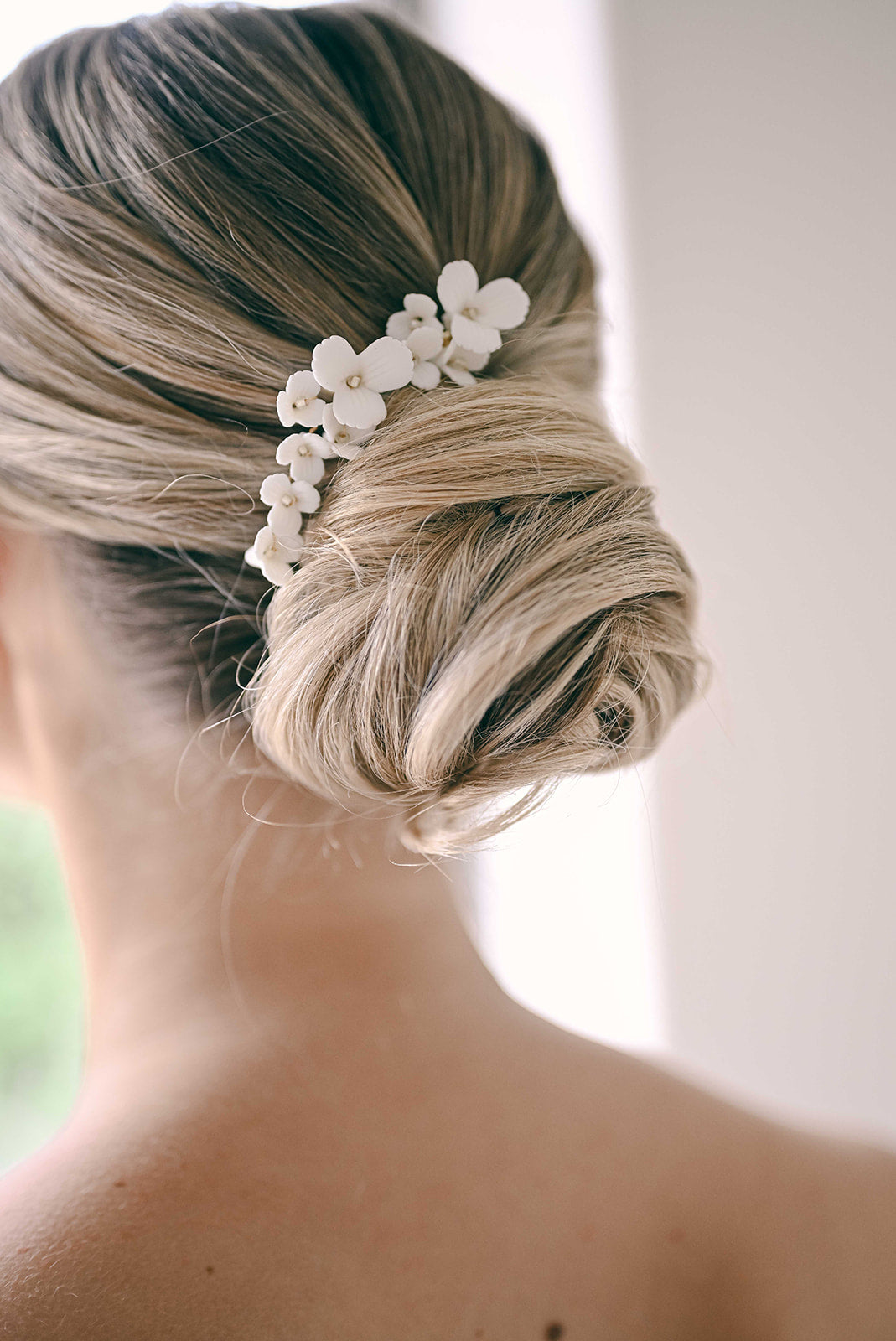 Bride wearing floral hair clip in updo