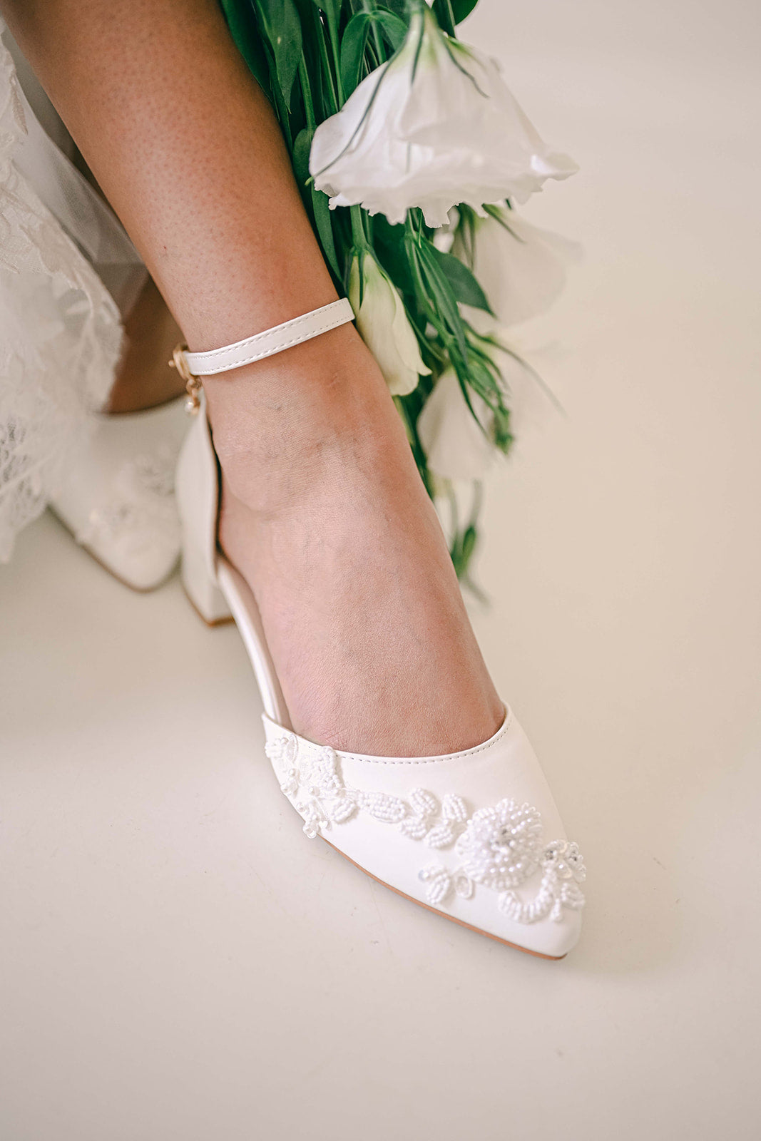 Bride wearing Ivory bridal block heel with beaded lace embellishment