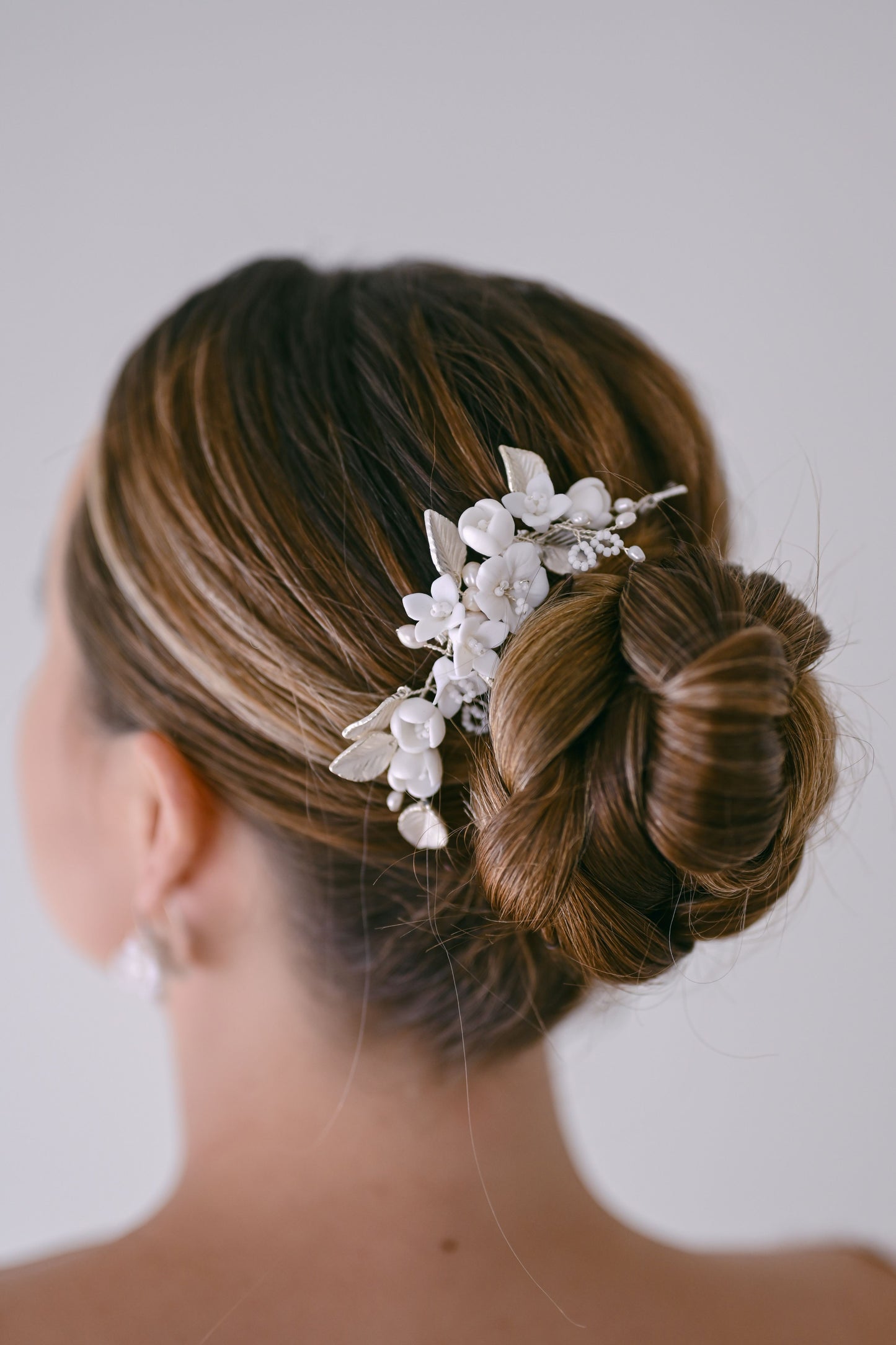 Bride wearing porcelain flower hair comb