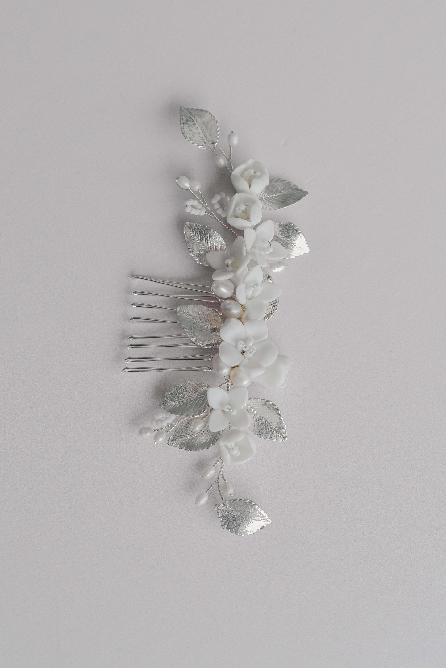 Silver bridal hair comb with porcelain flowers, fresh water pearls and leaf details.