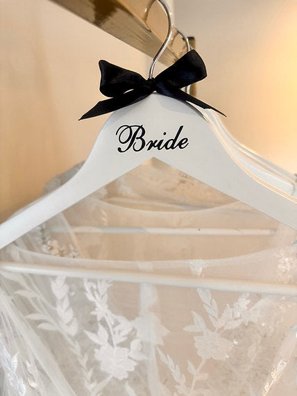 White hanger with Black bride letters and ribbon bow