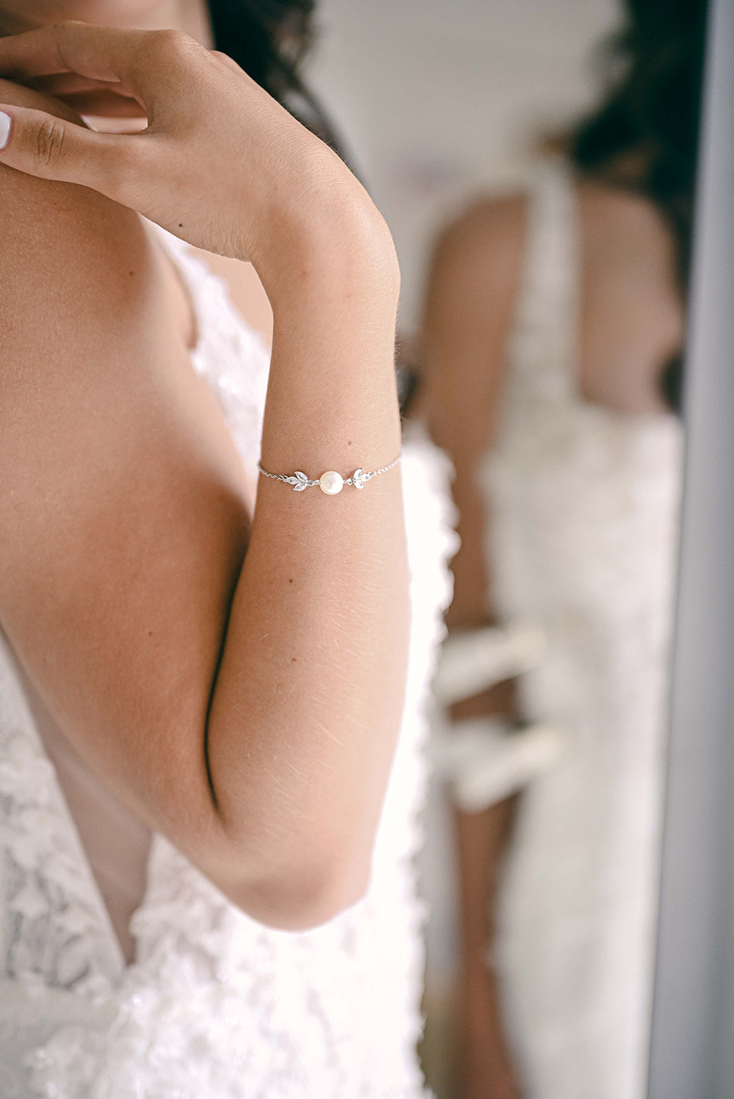 Bride wearing silver adjustable  bracelet with one pearl and cubic zirconia