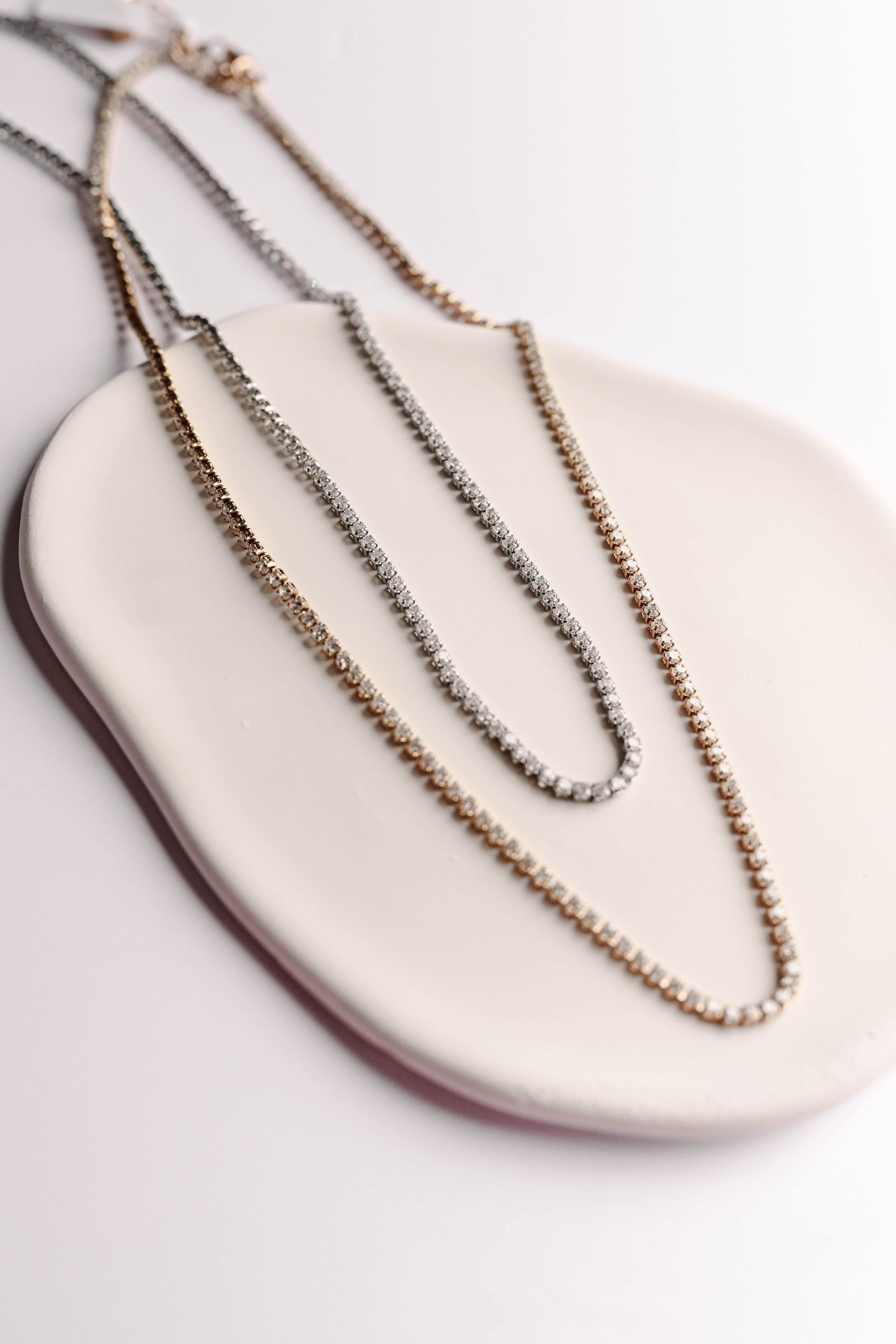 Stainless steel, 18K gold PVD plated necklace with 2mm cubic zirconia. Water and tarnish proof.