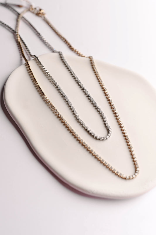 Stainless steel, 18K gold PVD plated necklace with 2mm cubic zirconia. Water and tarnish proof.