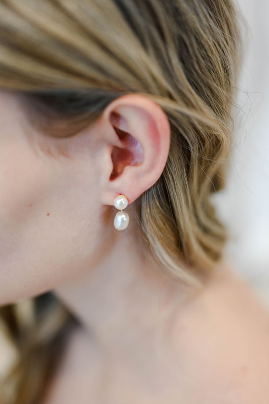 Bride wearing gold earrings with two small faux pearls