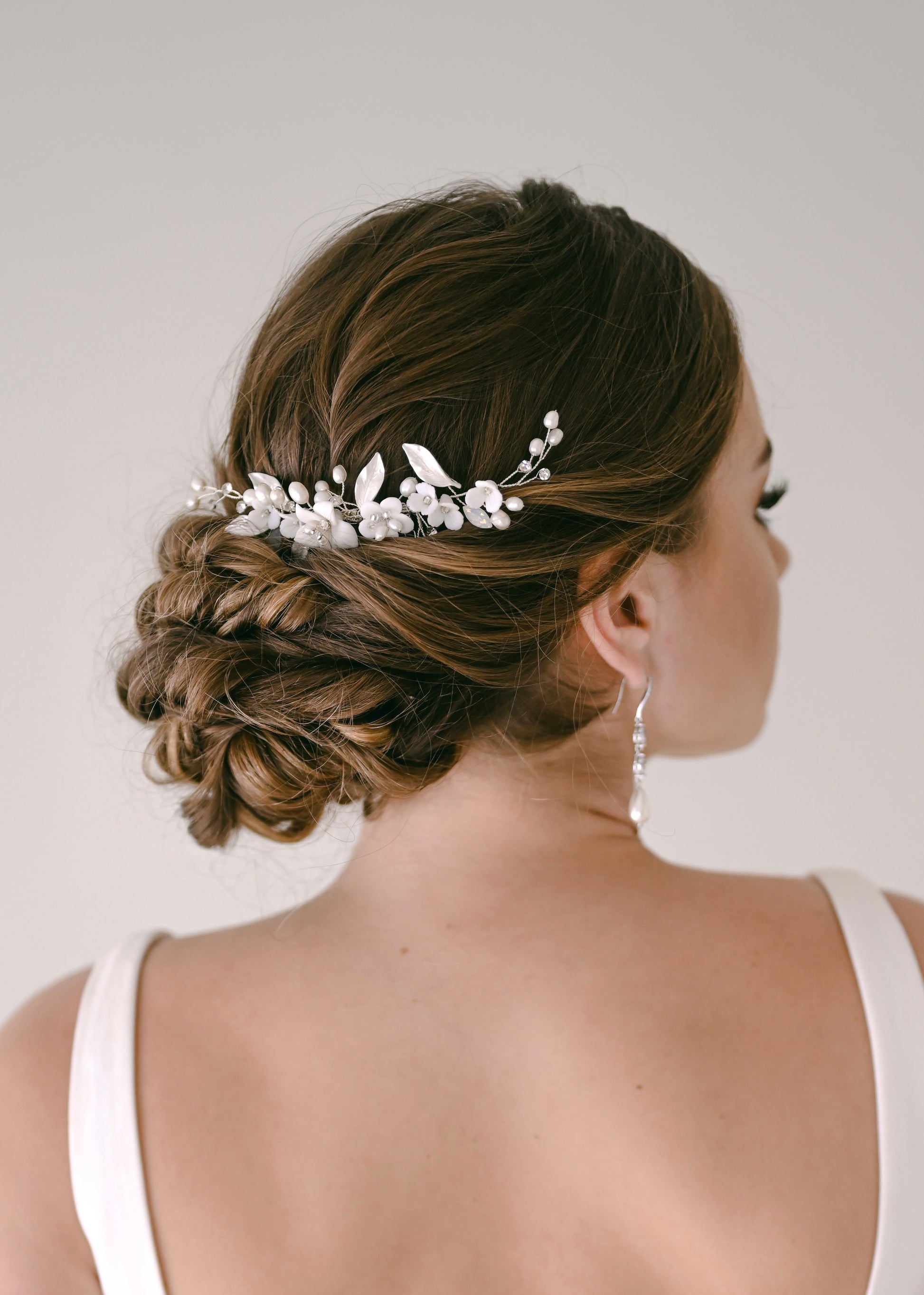 Bride wearing porcelain flower and fresh water pearl hair comb
