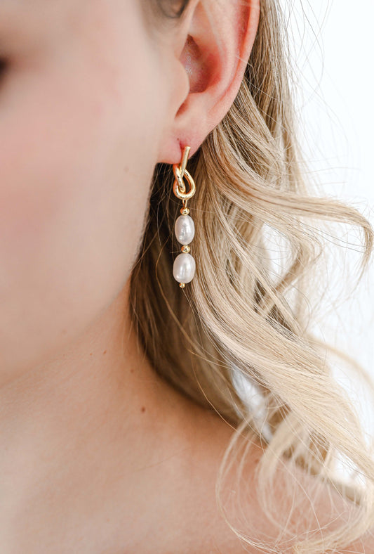 Bride wearing a gold knot earring with two freshwater pearls.