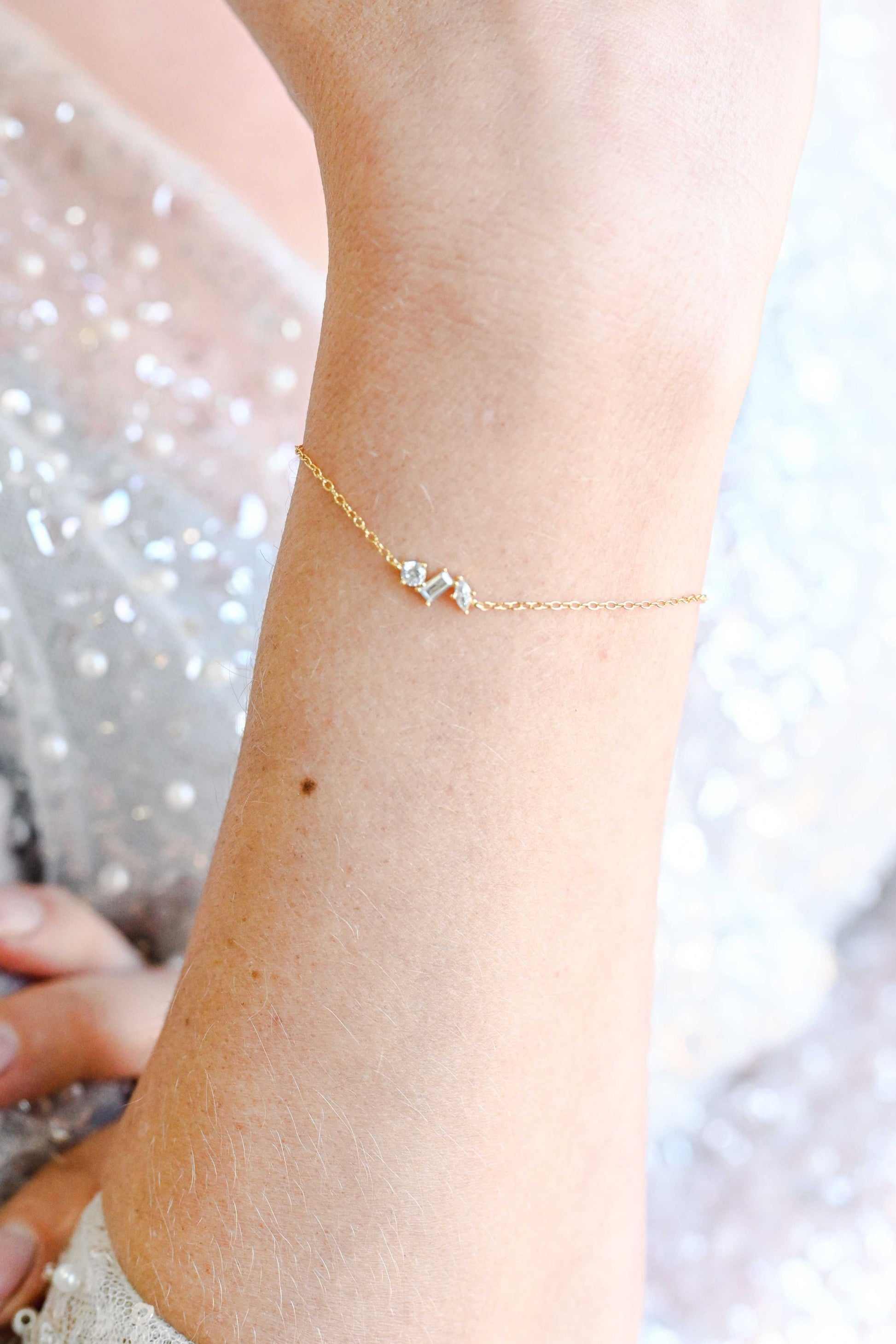 Bride wearing dainty gold geometric bracelet