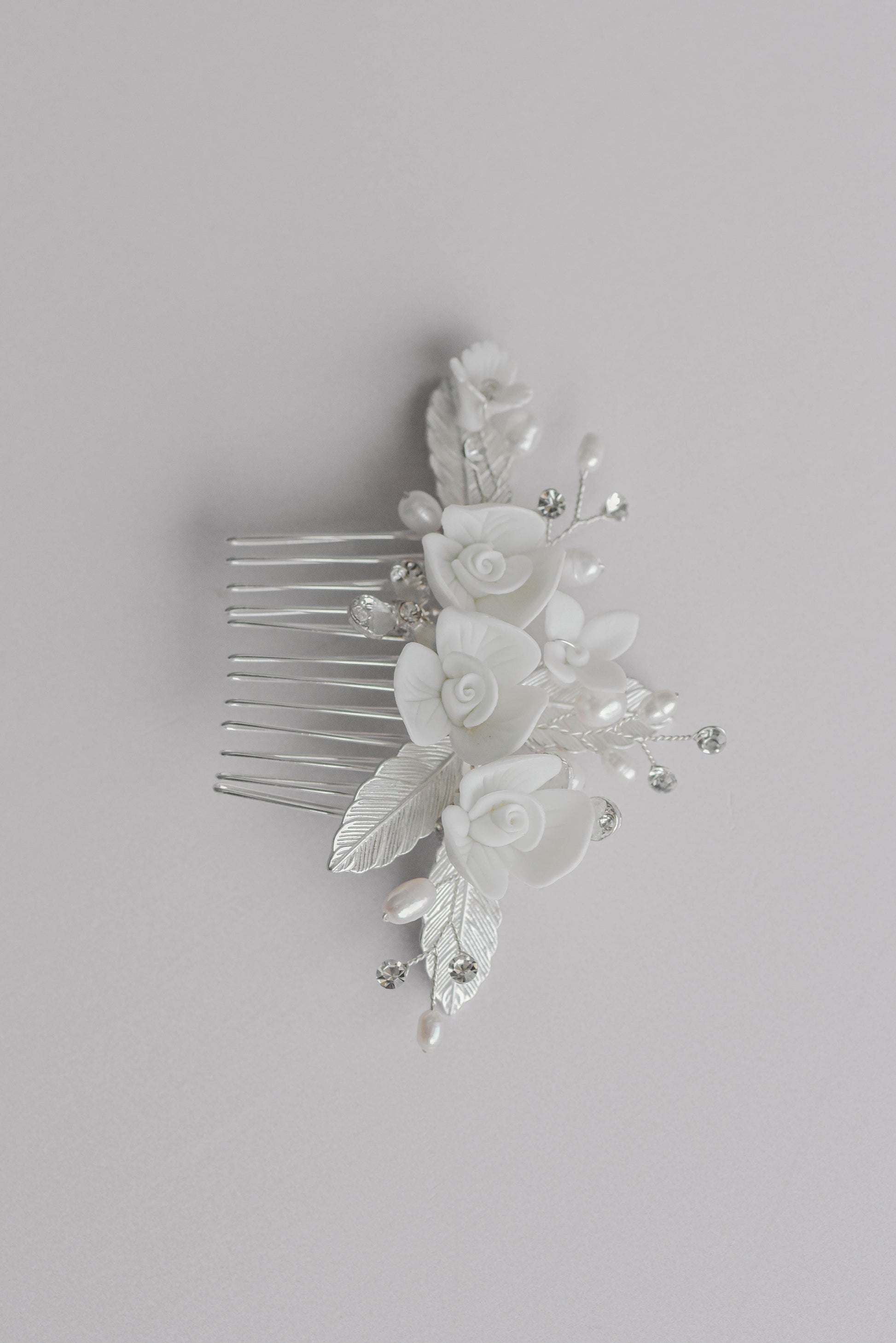 Silver bridal hair comb with porcelain flowers and leaf detail