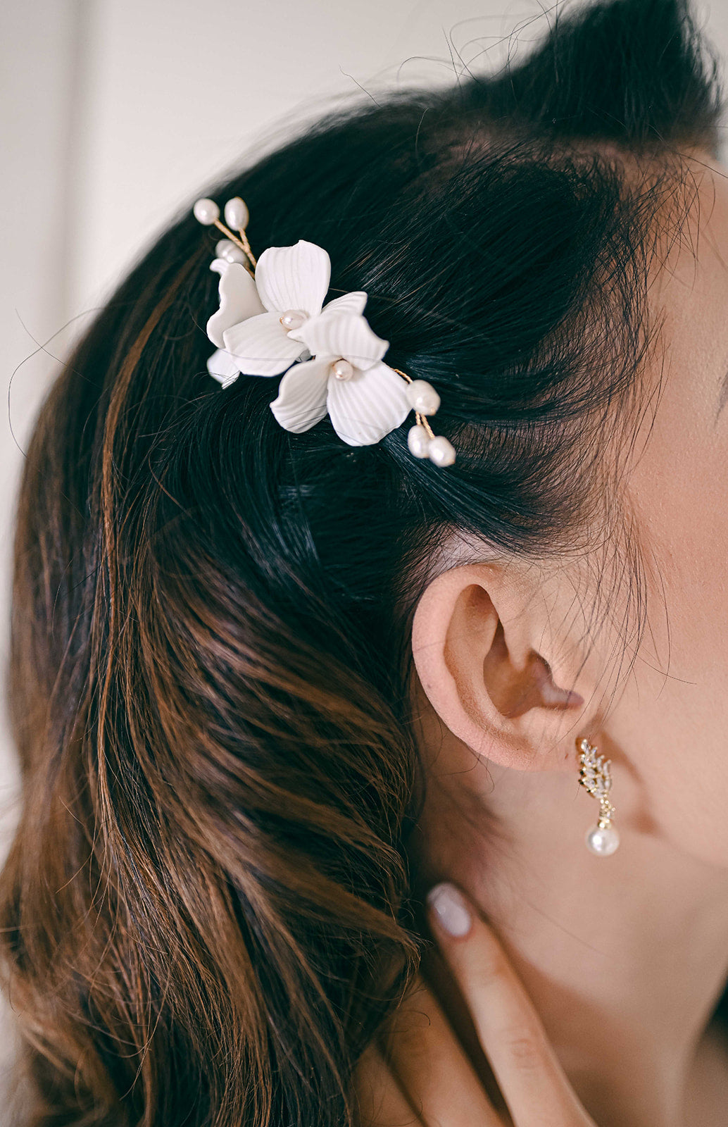 Bride wearing porcelain flower and fresh water pearl hair comb