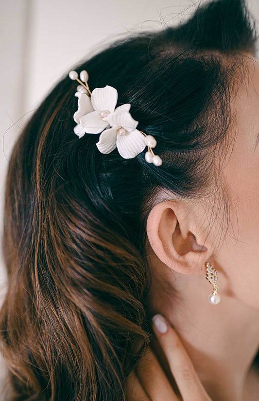 Bride wearing porcelain flower and fresh water pearl hair comb