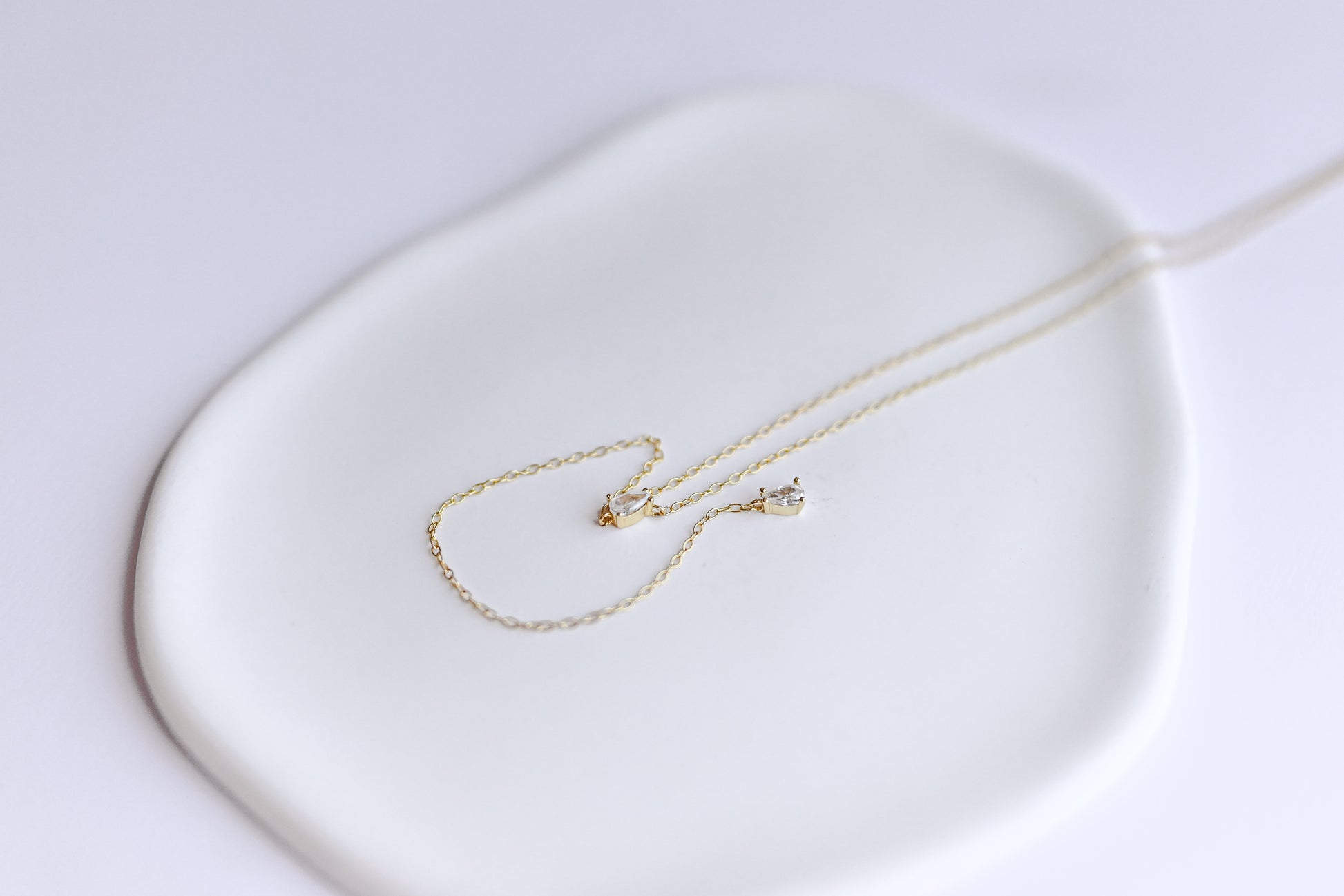 S925 sterling silver, gold plated lariat necklace with two teardrop Cubic Zirconia.