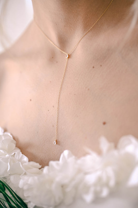 Bride wearing a S925 sterling silver, gold plated lariat necklace with two teardrop Cubic Zirconia.