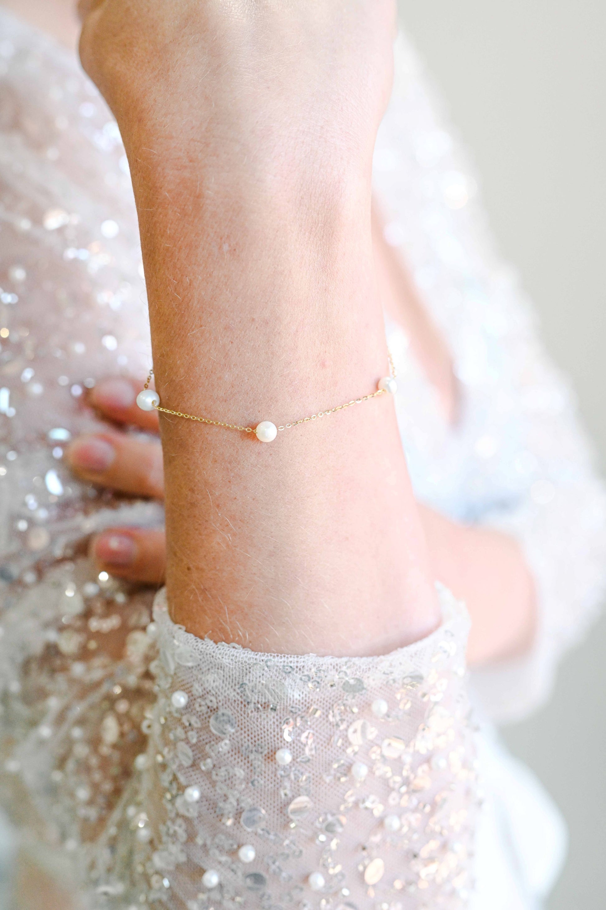 Bride wearing a sterling silver gold plated bracelet with fresh water pearls