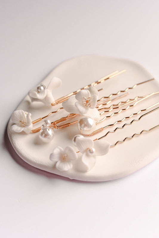 A set of 6 rose gold hair pins with porcelain flowers and pearls
