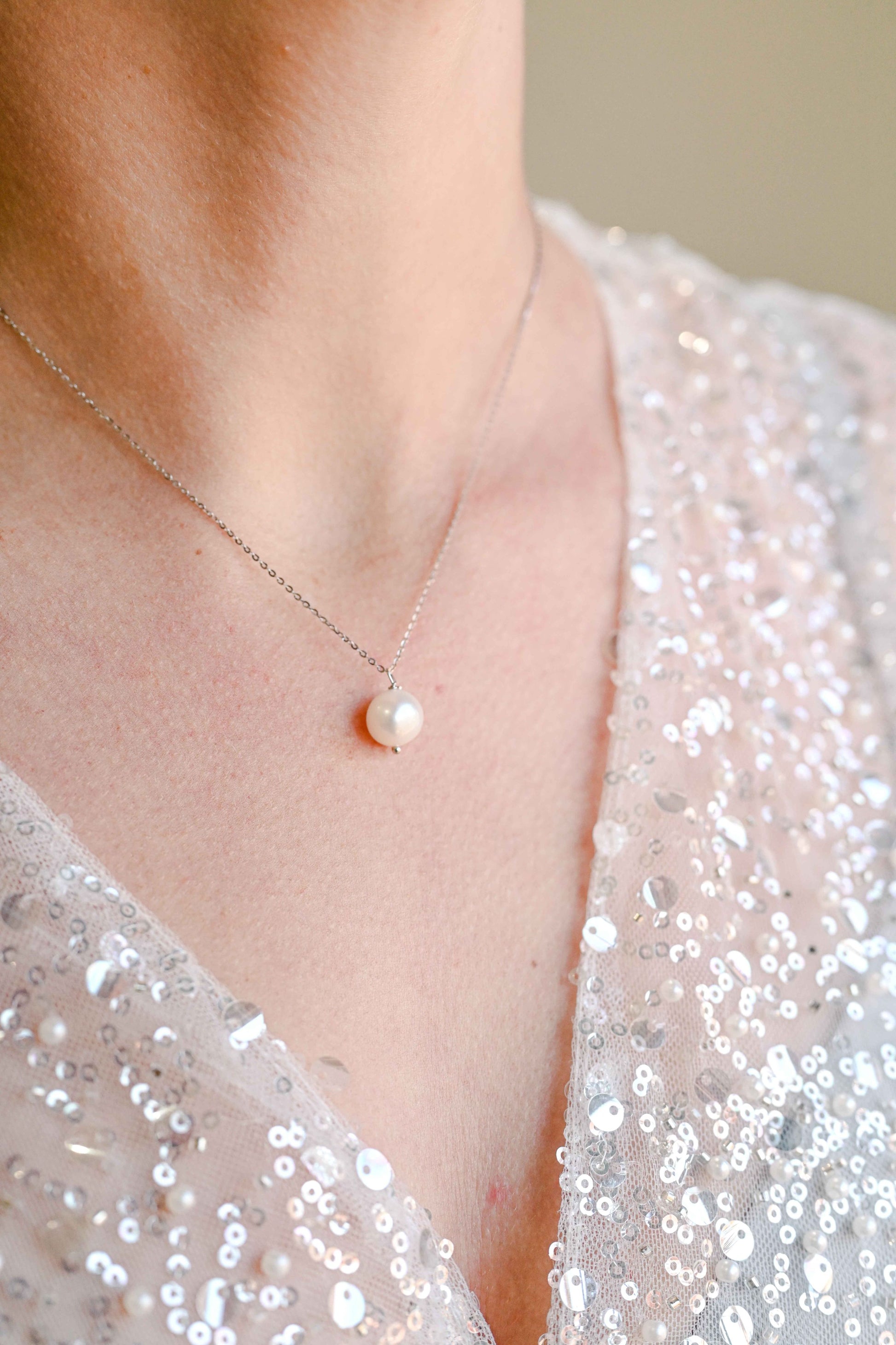 Bride wearing sterling silver necklace with a natural fresh water baroque pearl