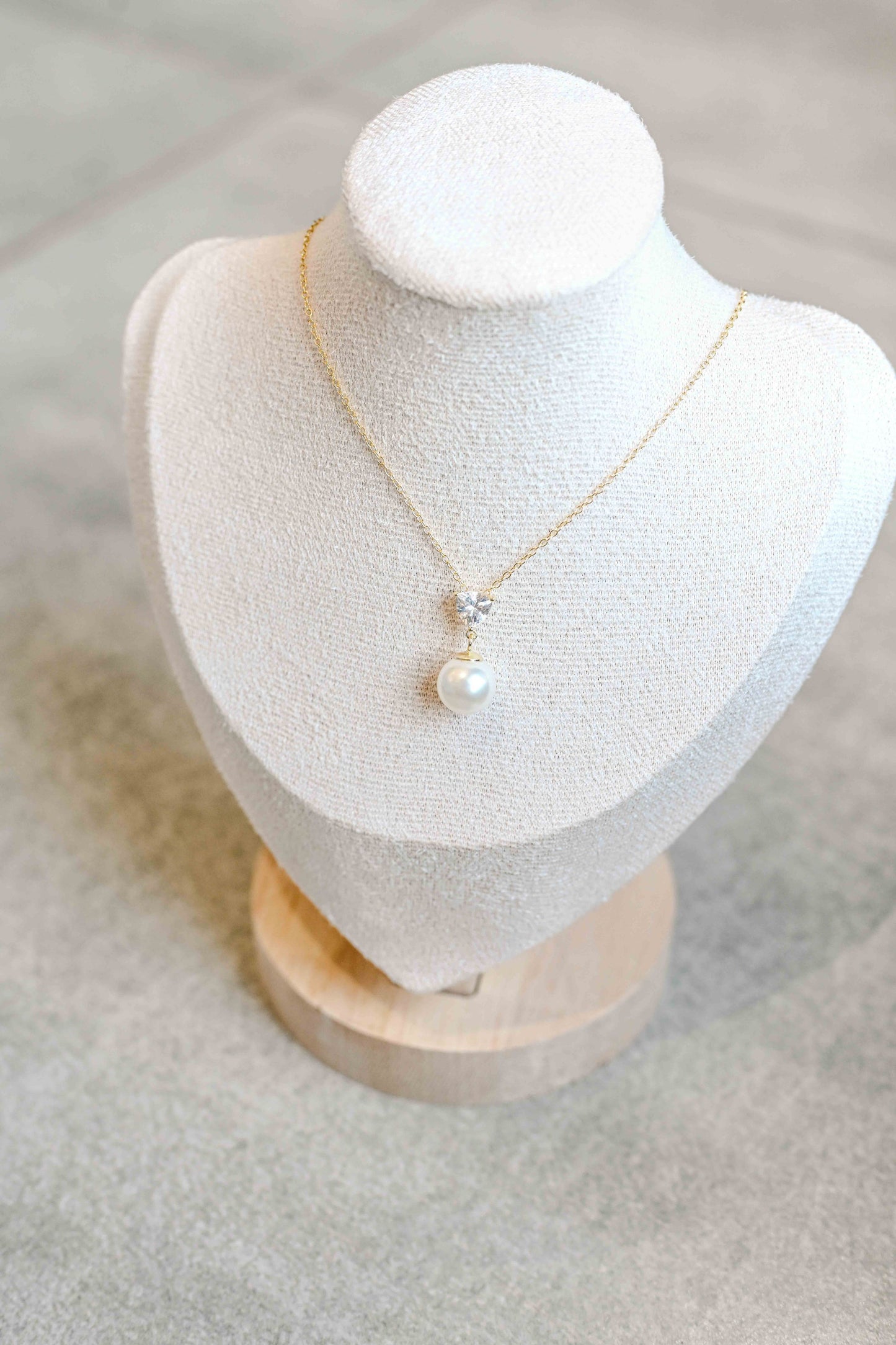 S925 sterling silver, gold plated necklace with a triangle cubic zirconia and pearl detail.