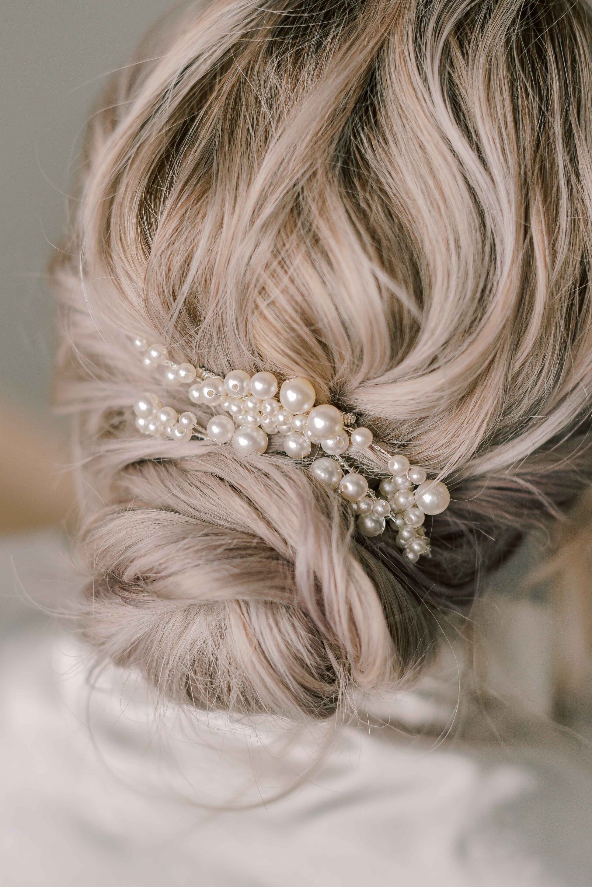 Bride wearing pearl pins hair accessories
