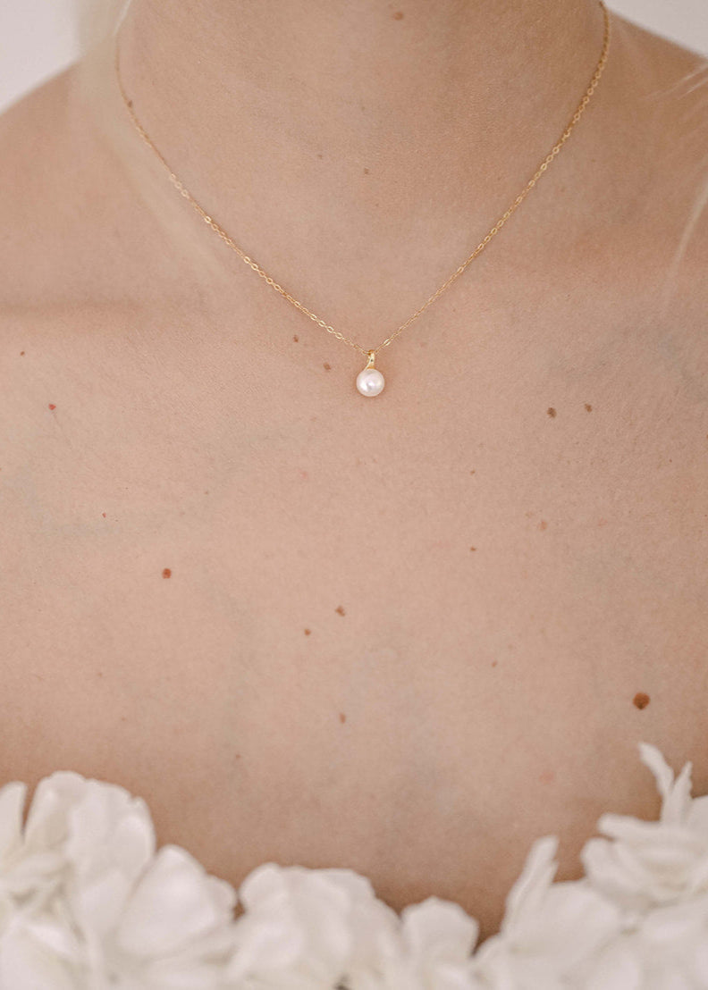 Bride wearing S925 sterling silver, gold plated necklace with a fresh water pearl.