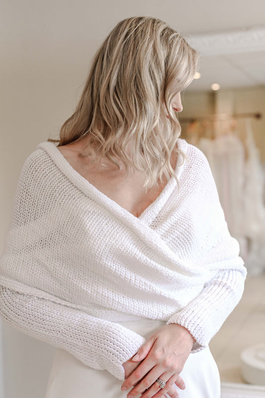 Hand knitted bridal shawl worn over a wedding dress in winter