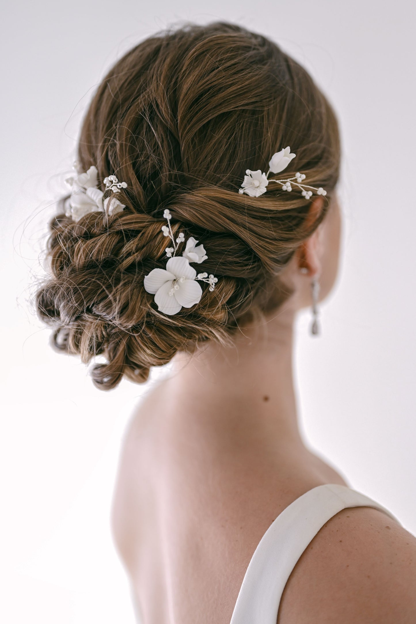 Bride wearing porcelain flower hair pins