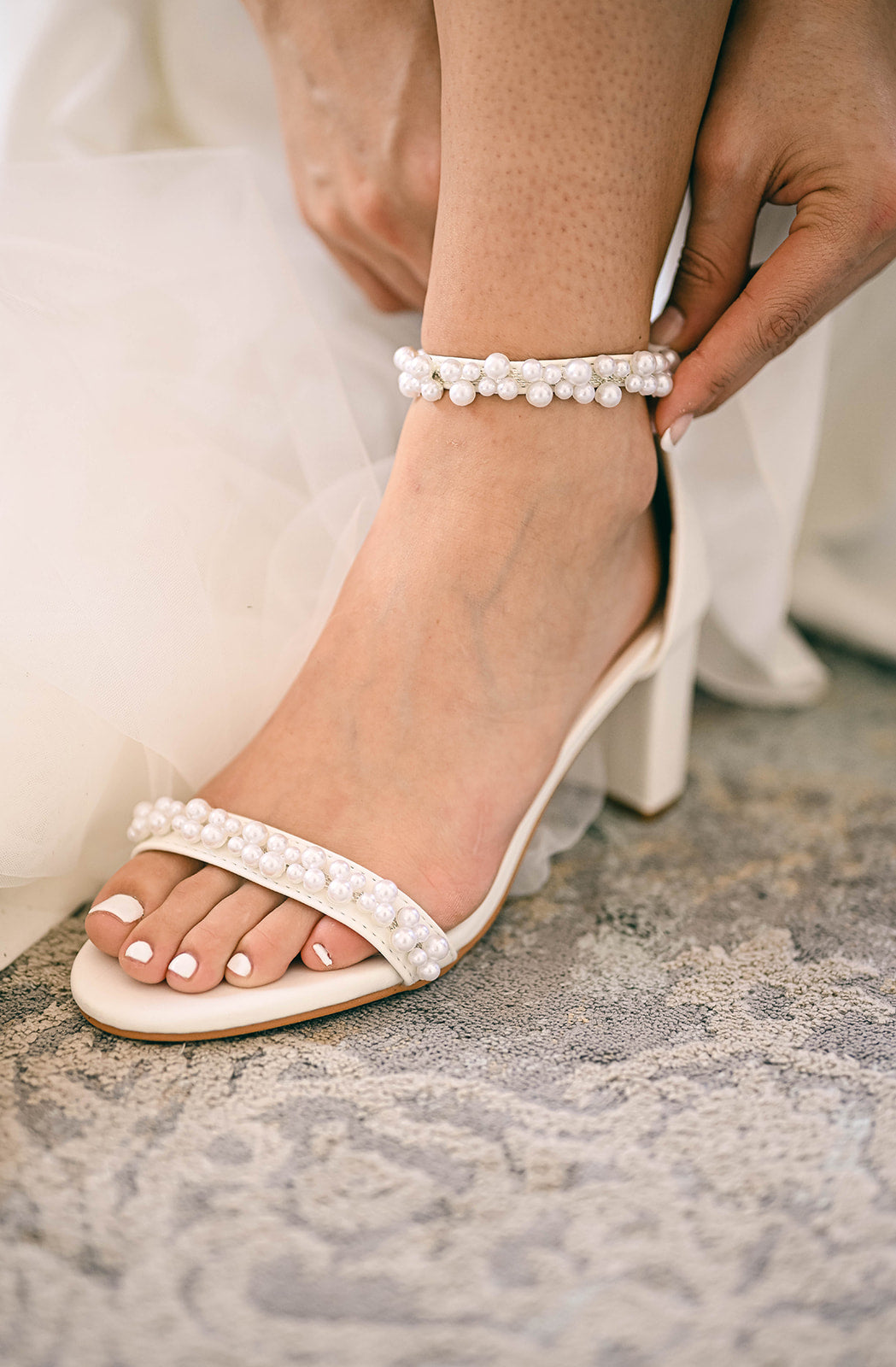 Bride wearing open toe bridal 7cm block heel with pearls on straps
