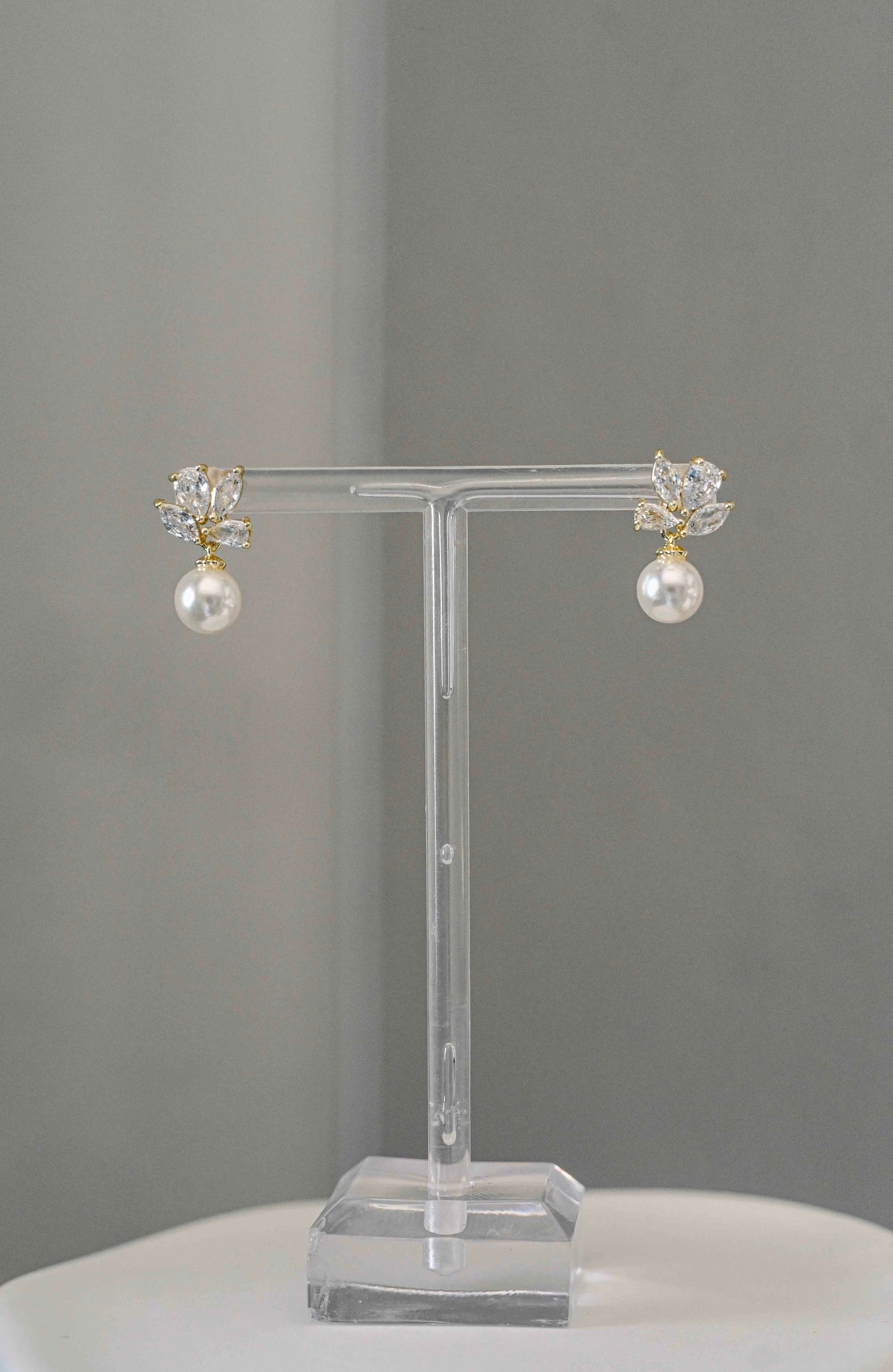 Gold bridal earring with geometric cubic zirconia and drop pearl