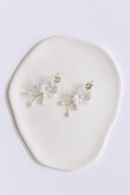 Gold bridal earring with single porcelain flower and fresh water pearls.