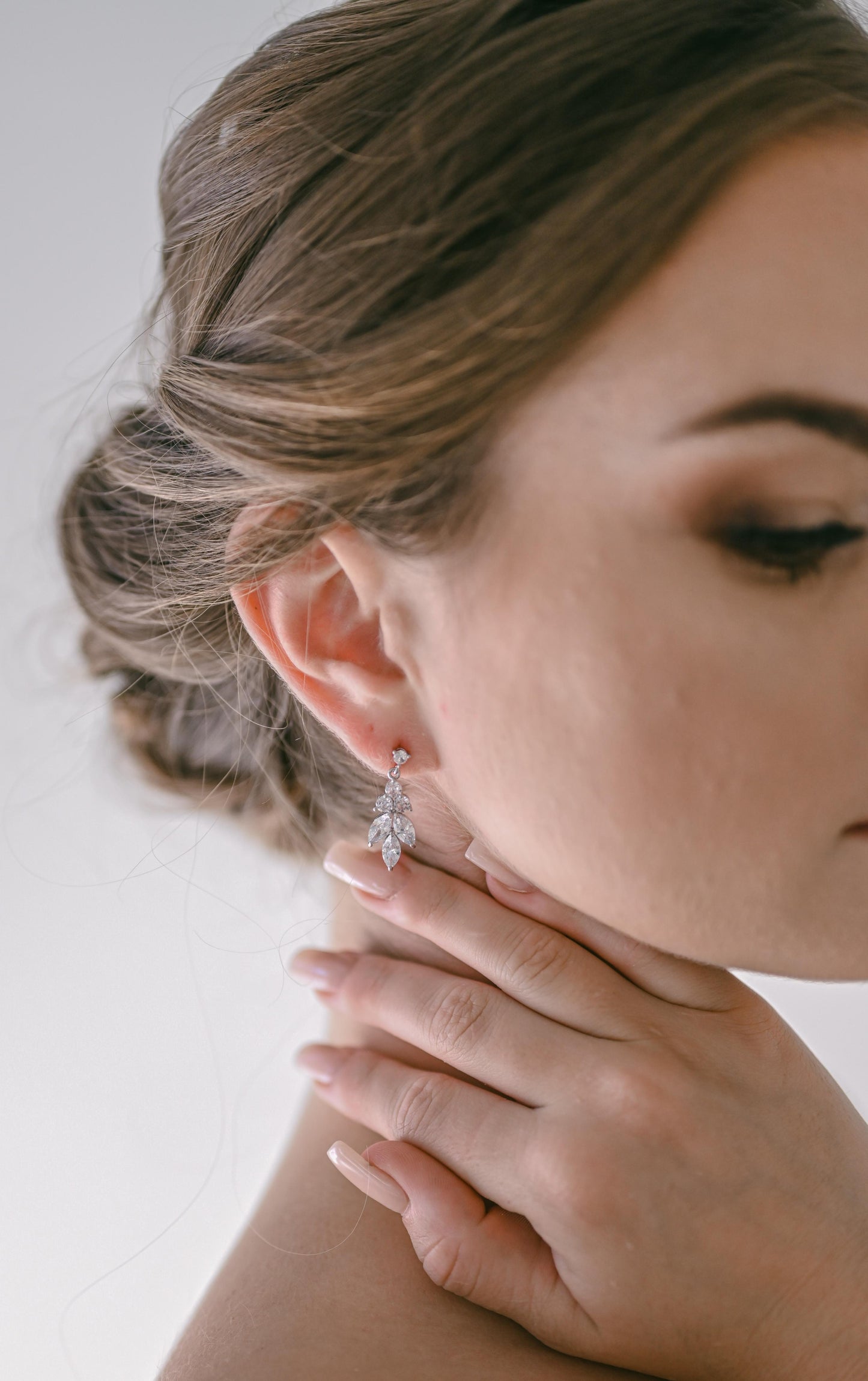 Bride wearing cubic zirconia leaf design bridal earring