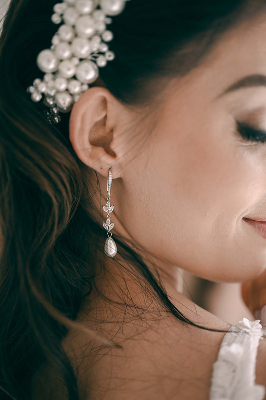 Bride wearing cubic zirconia and pearl earring