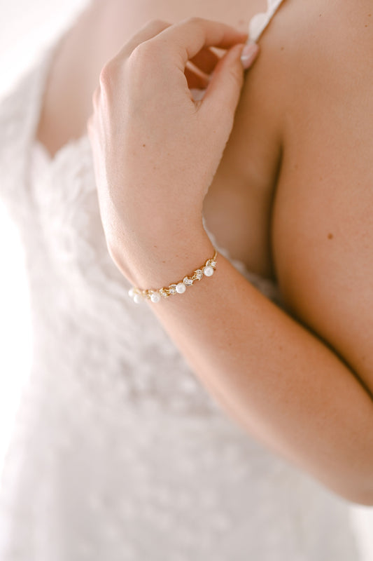 Bride wearing adjustable pearl and cubic zirconia bracelet