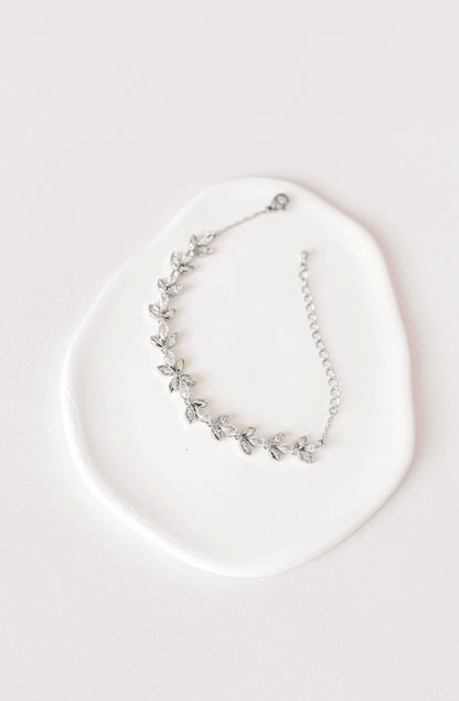 Silver bridal bracelet with cubic zirconia leaf design.