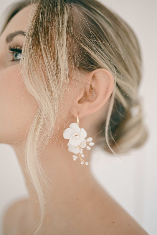 Woman wearing bridal flower earrings with fresh water pearls