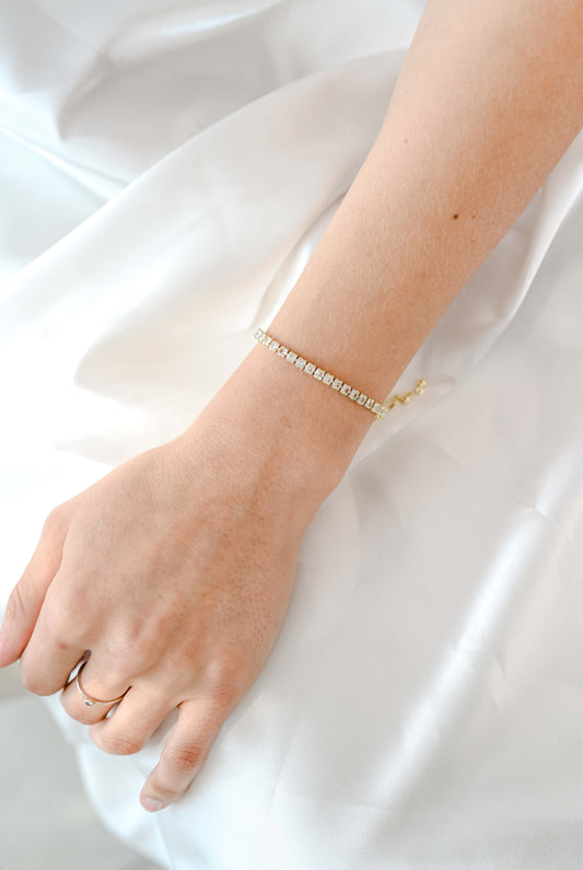 A delicate gold adjustable slide bracelet with cubic zirconia.