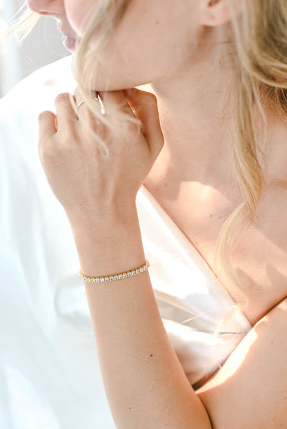 A delicate gold adjustable slide bracelet with cubic zirconia.