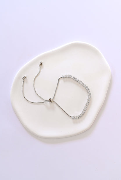 A delicate silver adjustable slide bracelet with cubic zirconia.