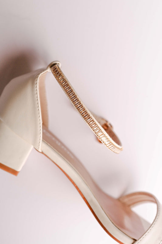 Ivory bridal block heel with open toe design and gold cubic zirconia embellished ankle strap