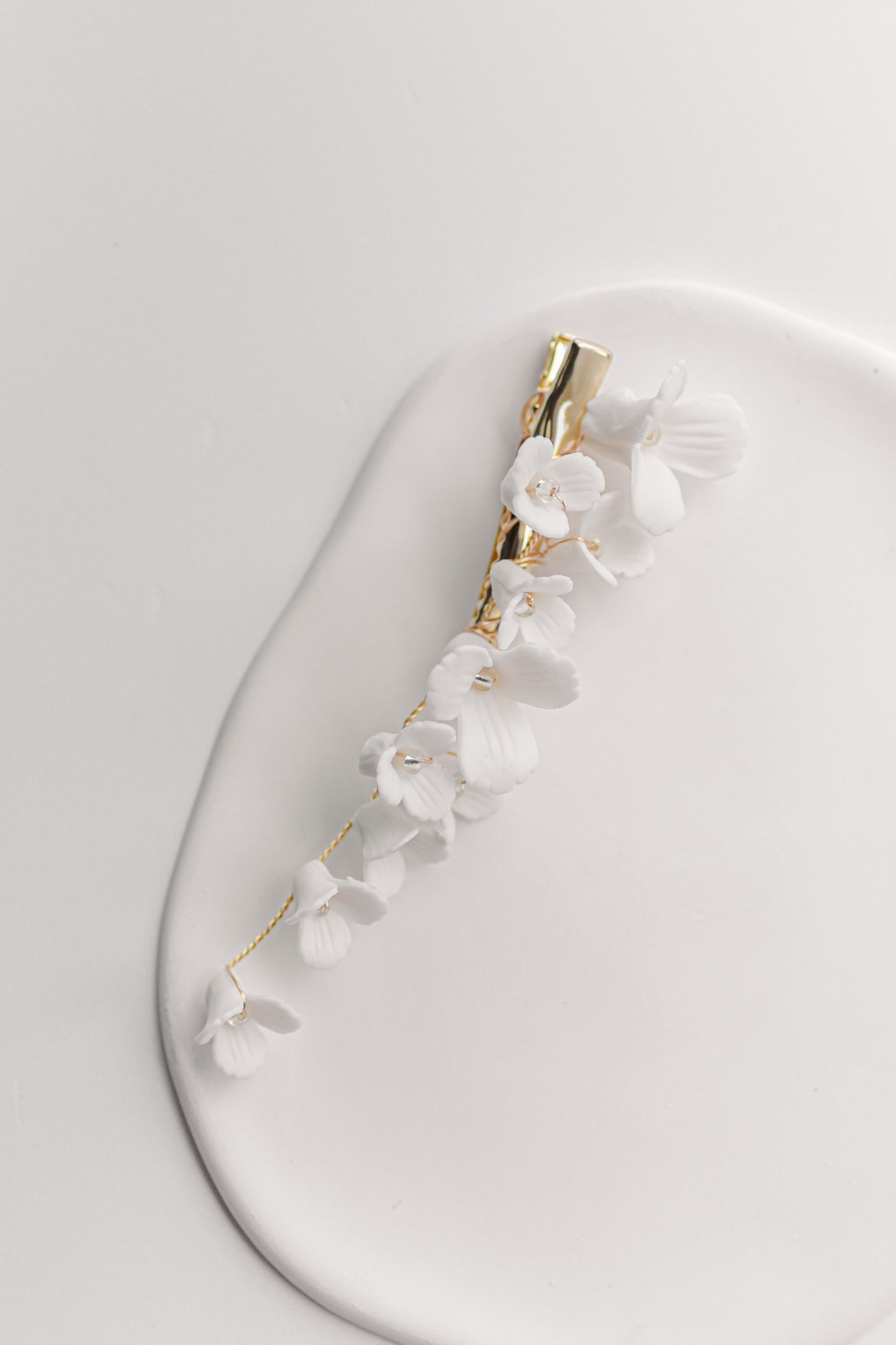 Gold bridal hair clip with porcelain flowers