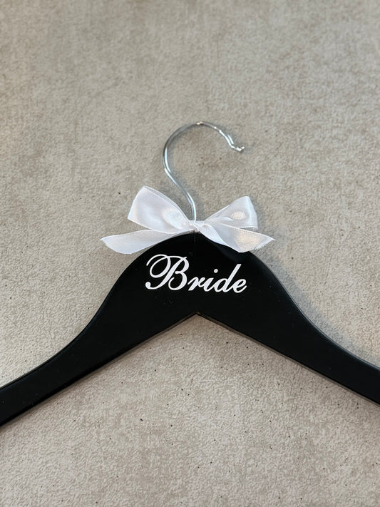 Black wooden bridal hanger with bow.
