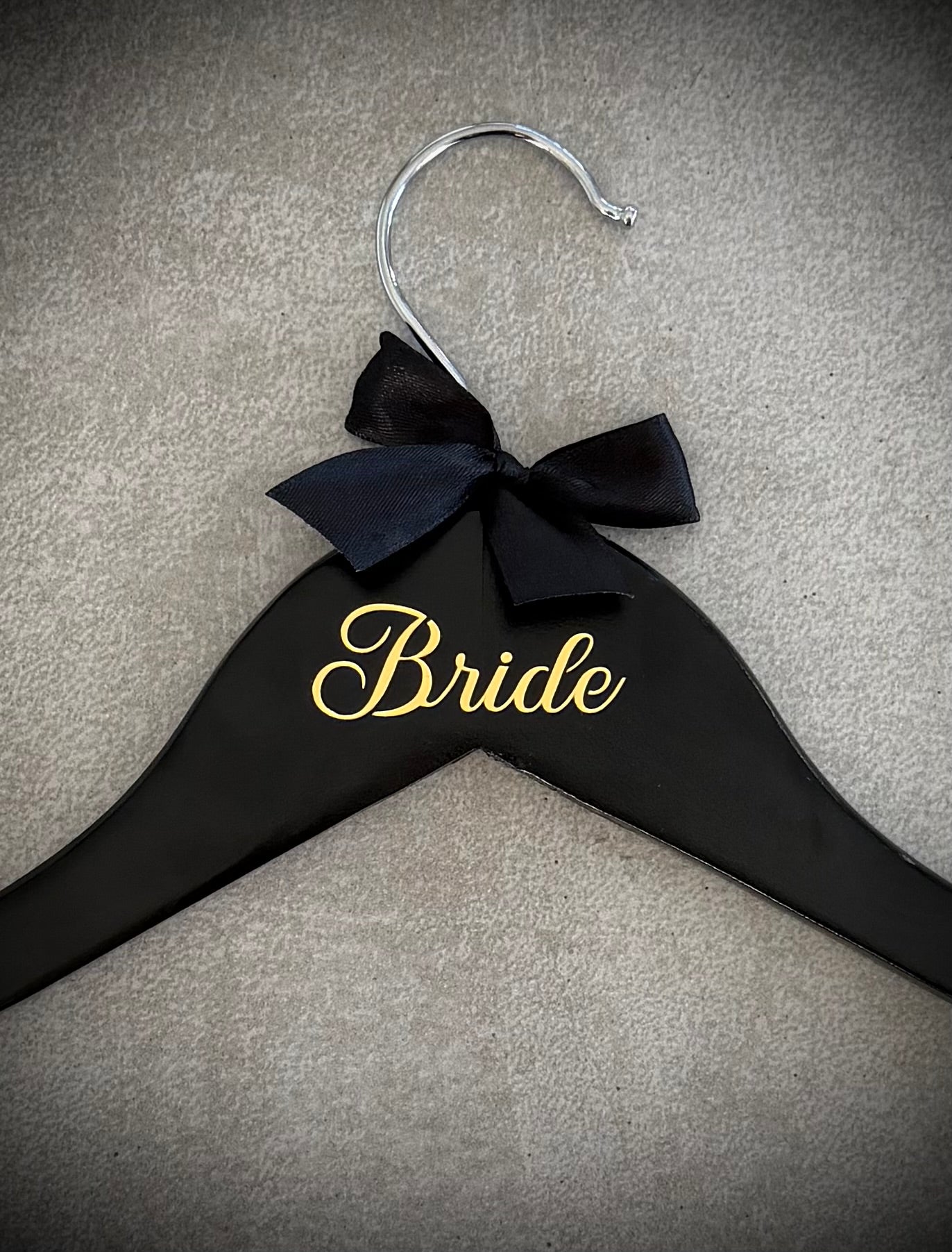 Black wooden hanger with gold vinyl Bride and a white ribbon bow