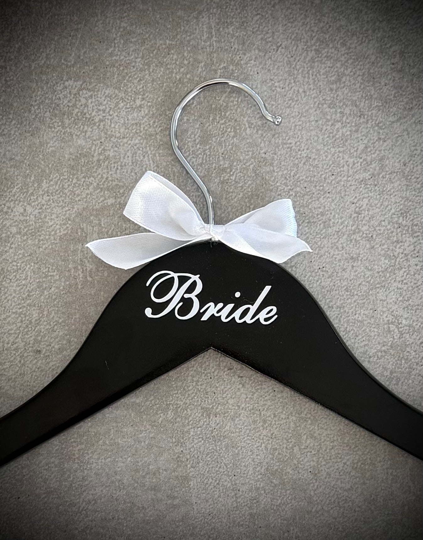 Black wooden hanger with white vinyl Bride and a white ribbon bow