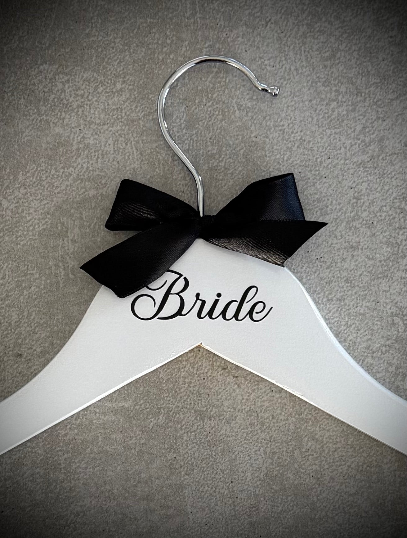 White wooden hanger with black vinyl Bride and a black ribbon bow