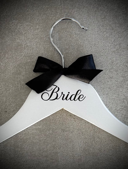 White wooden hanger with black vinyl Bride and a black ribbon bow