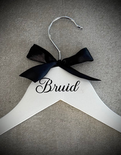 White wooden hanger with black vinyl Bruid and a black ribbon bow