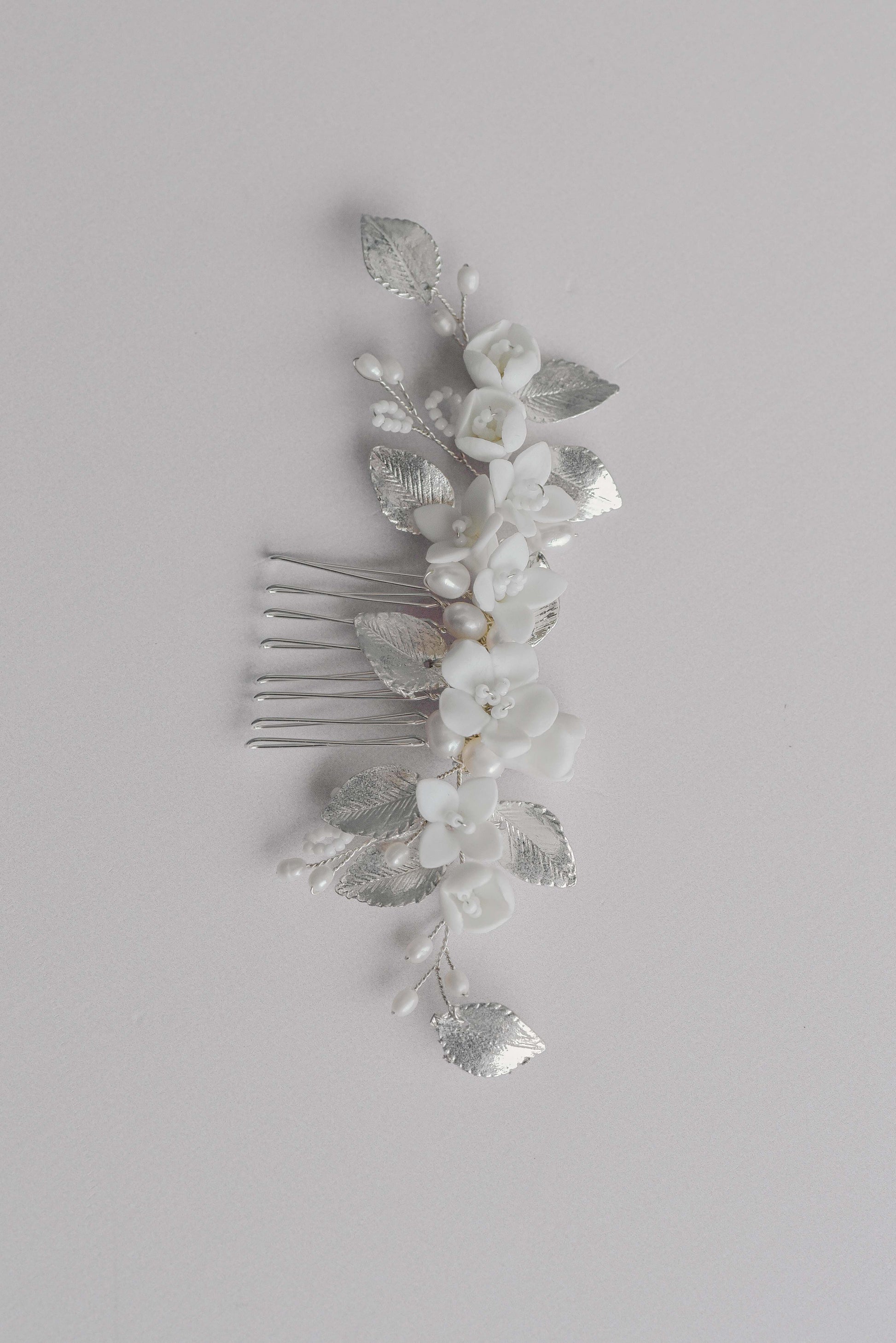 Silver bridal hair comb with porcelain flowers, fresh water pearls and leaf details.