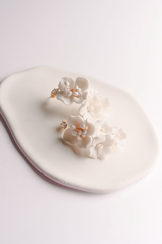 Gold bridal earrings with a cluster of porcelain flowers